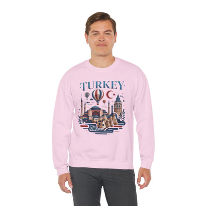 Light pink crewneck sweatshirt with colorful Turkey skyline graphic on the front, worn by model.
