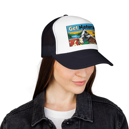 Black and white trucker hat with front alpine graphic patch; worn by a person.