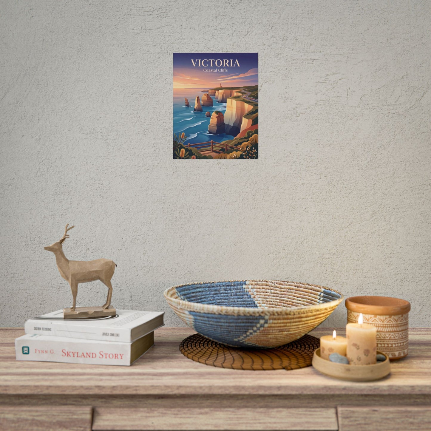 Rolled Australia coastal cliffs poster above dresser, showing cliffs, lighthouse, and ocean