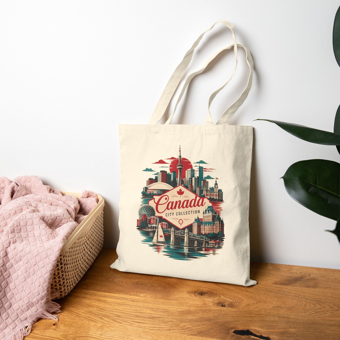Natural tote bag with Canada skyline graphic and red “Canada” logo on front