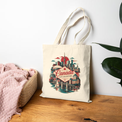 Natural tote bag with Canada skyline graphic and red “Canada” logo on front