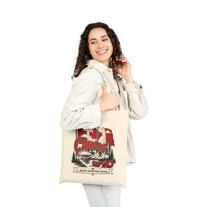 Natural canvas tote bag with Canada flag canoe graphic, carried by person