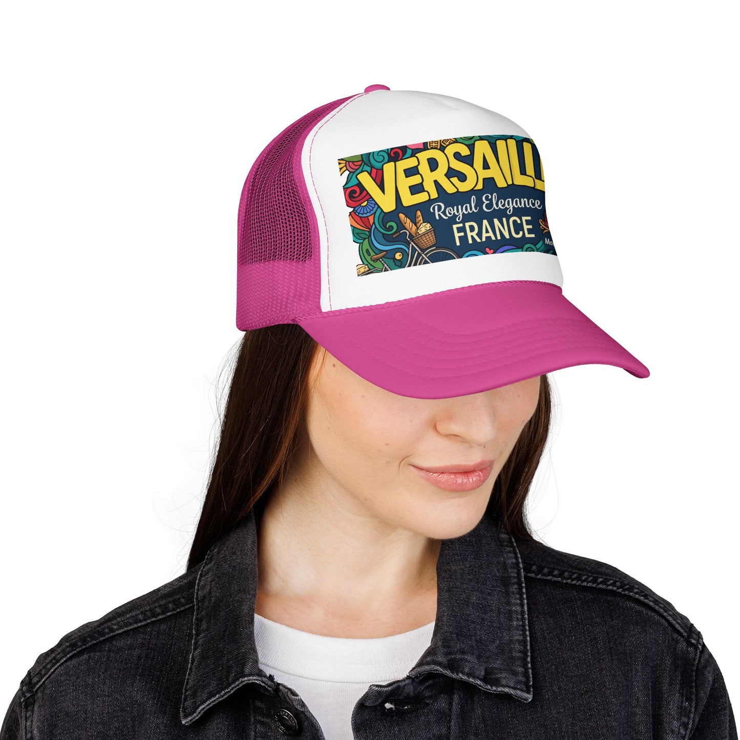 Pink trucker hat with white front panel and “VERSAILLES” France graphic patch.