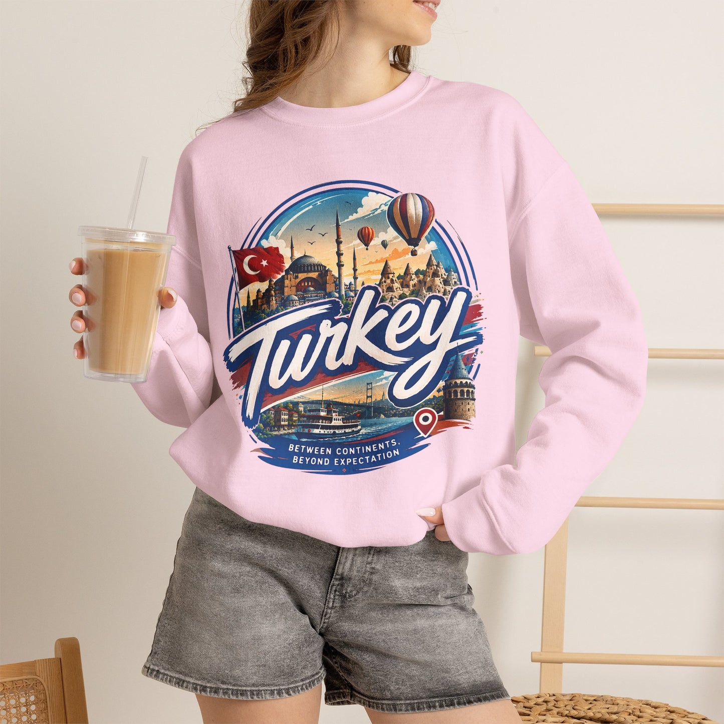 Light pink crewneck sweatshirt with Turkey graphic, worn on model