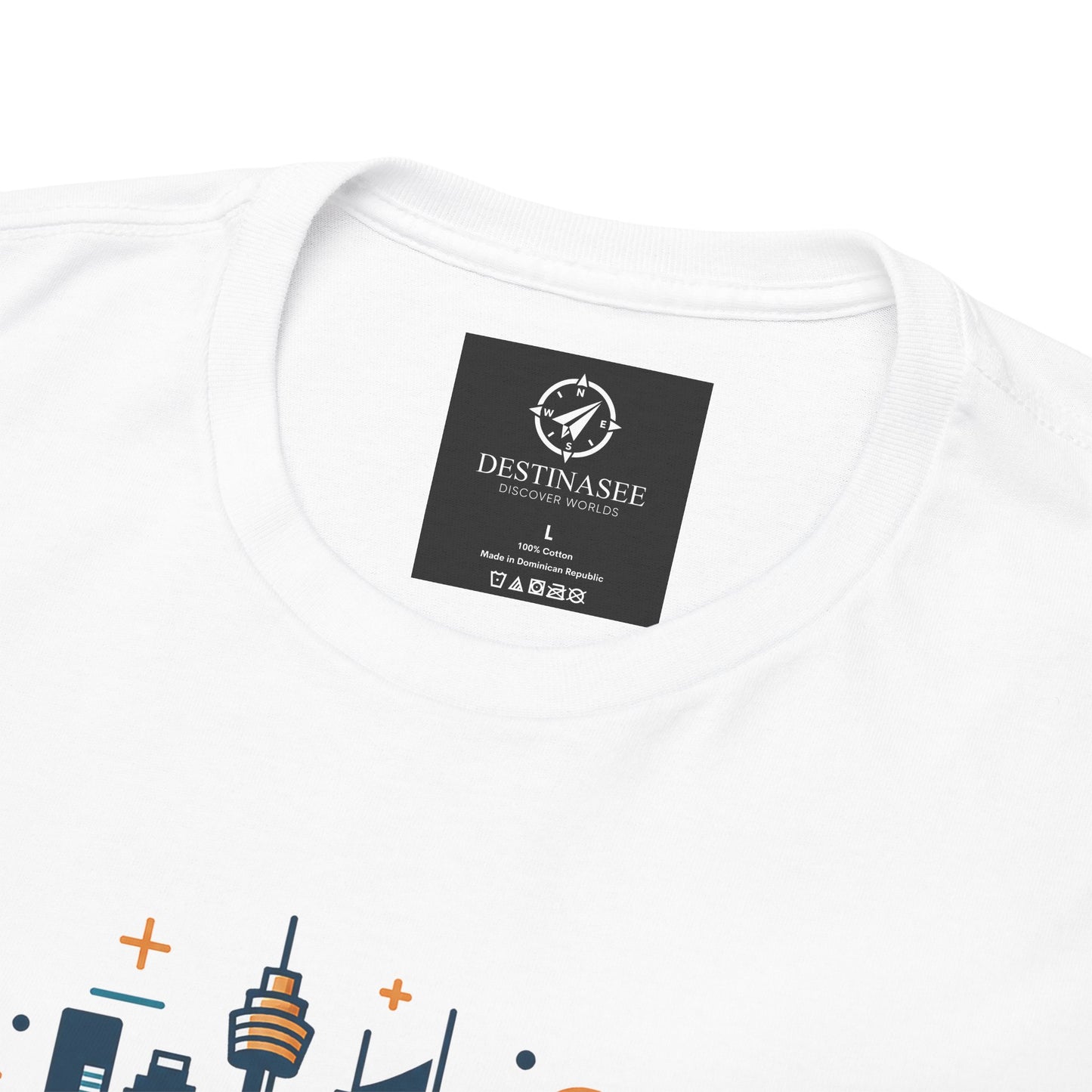 White T-shirt close-up: round neck label patch and partial colorful Sydney skyline print.
