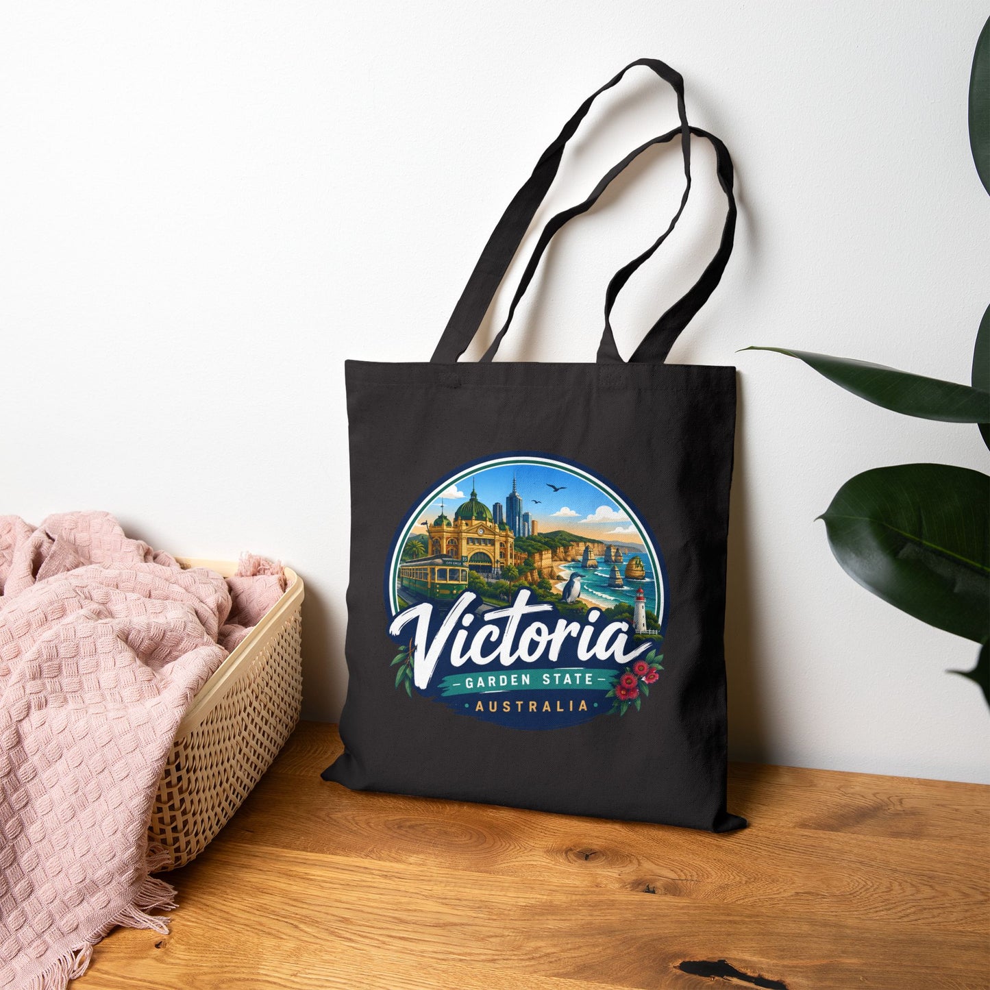 Black vintage travel tote bag with circular Victoria Australia logo graphic on front