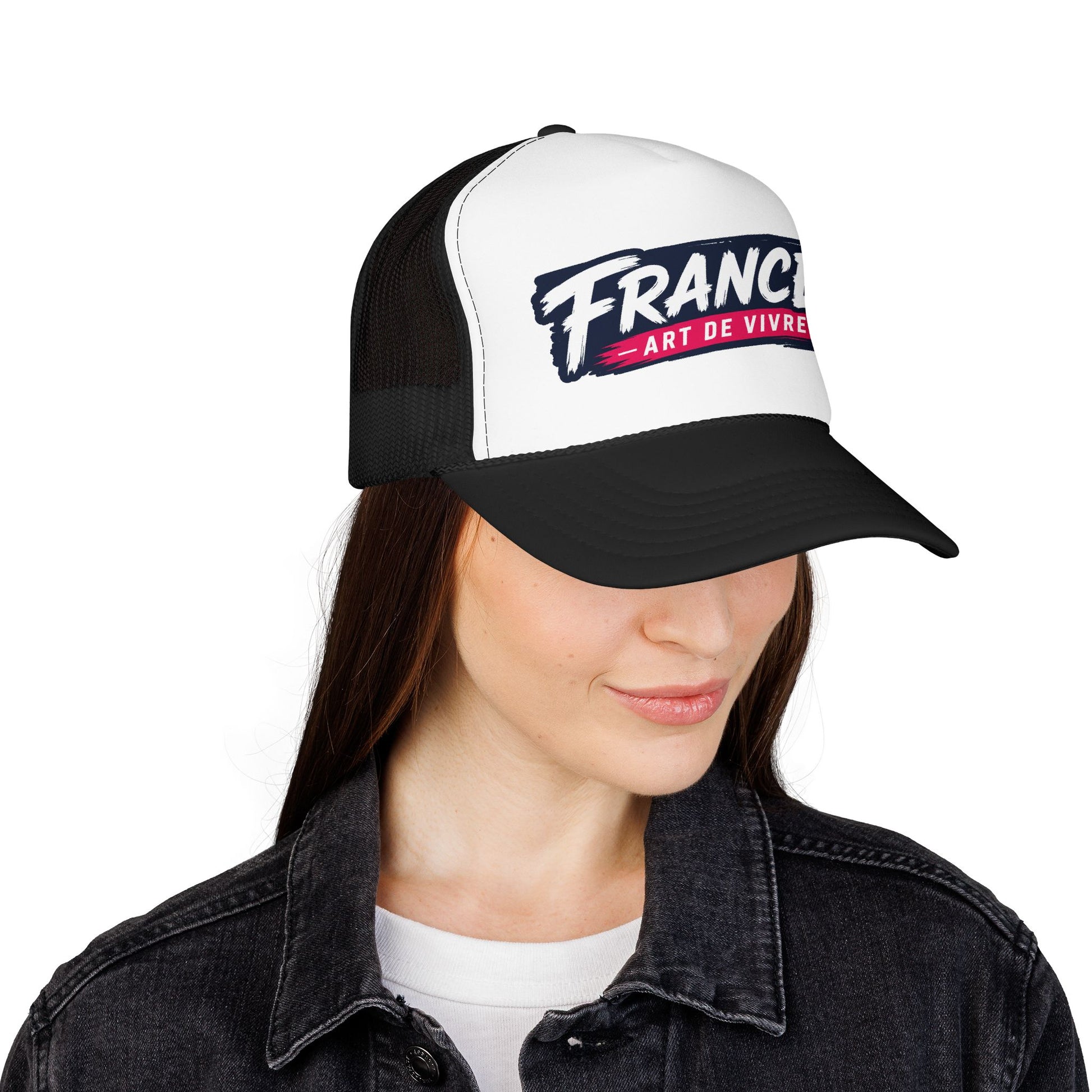 Trucker hat worn on head: white front with 'FRANCE' graphic, black mesh sides, black brim