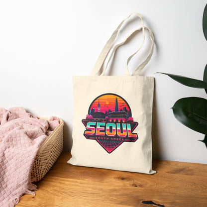 Natural canvas tote bag with Seoul skyline logo, flat lay with long handles