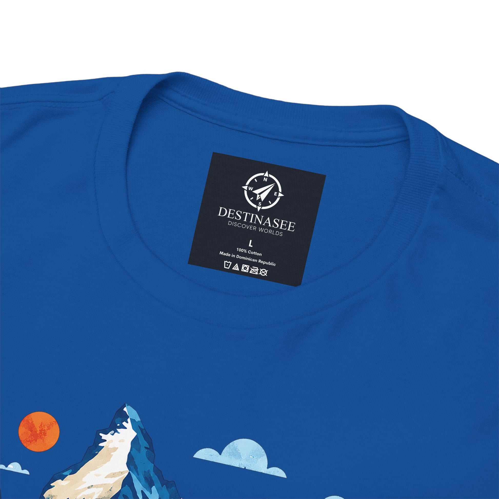 Royal blue T-shirt back neck label and partial Switzerland village artwork
