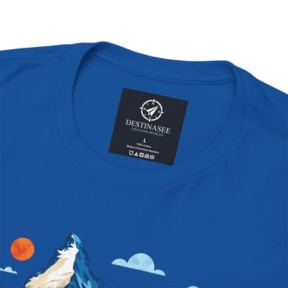Royal blue T-shirt back neck label and partial Switzerland village artwork