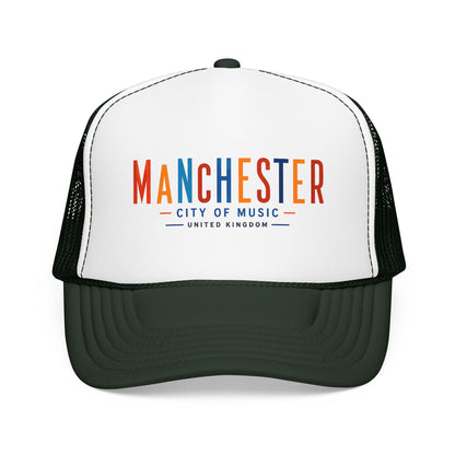 White trucker hat with black mesh sides and dark green curved brim; Manchester City of Music logo.