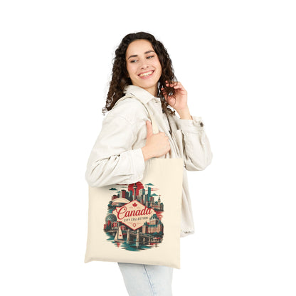Natural tote bag with Canada skyline graphic carried by a smiling person
