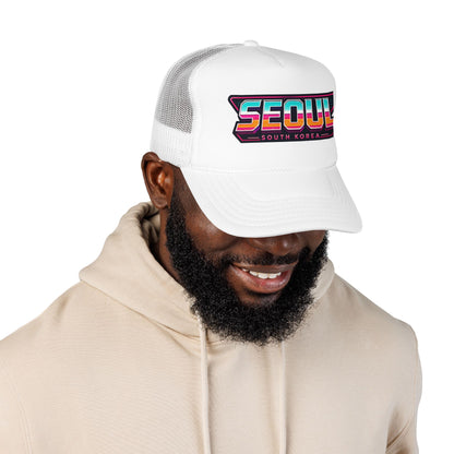 White trucker hat with “SEOUL SOUTH KOREA” front logo patch on breathable mesh panels.