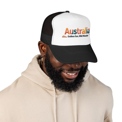 Black-and-white trucker cap with orange Australia logo, worn by model