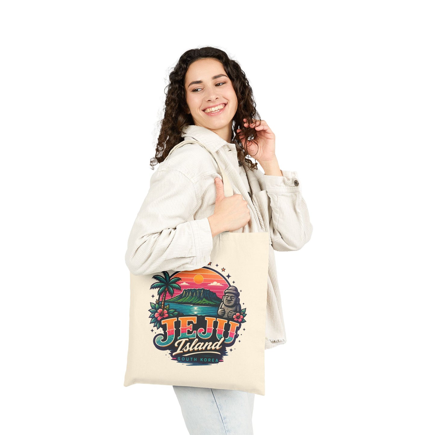 Natural canvas tote bag worn in front, featuring colorful Jeju Island graphic