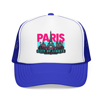 White trucker hat with royal blue mesh sides and Paris City of Lights graphic, curved brim.