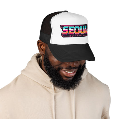 Black and white trucker hat worn by man, side view of Seoul logo graphic