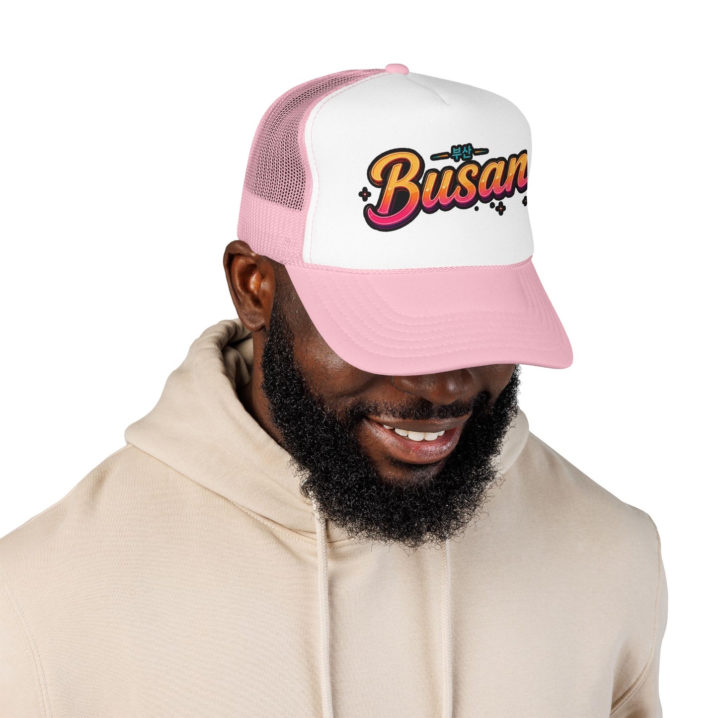 Pink and white trucker hat with curved brim and 'Busan' front logo