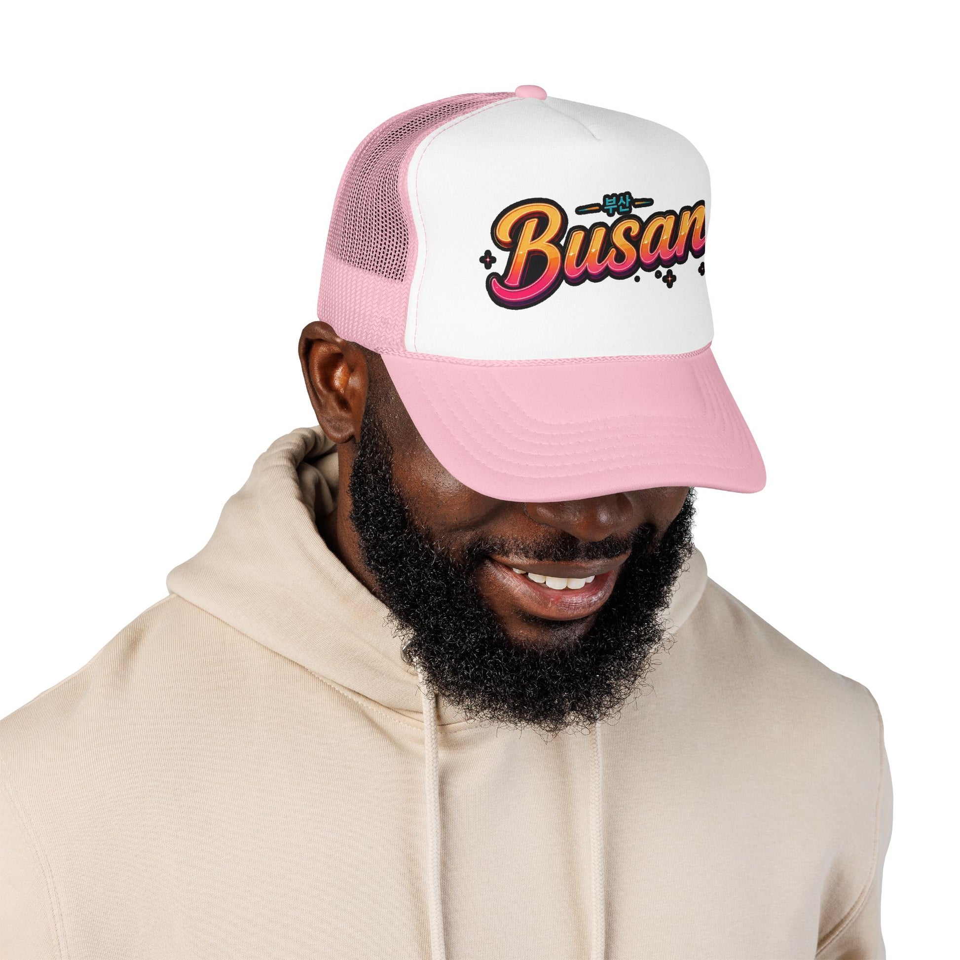 Pink and white trucker hat with curved brim and 'Busan' front logo