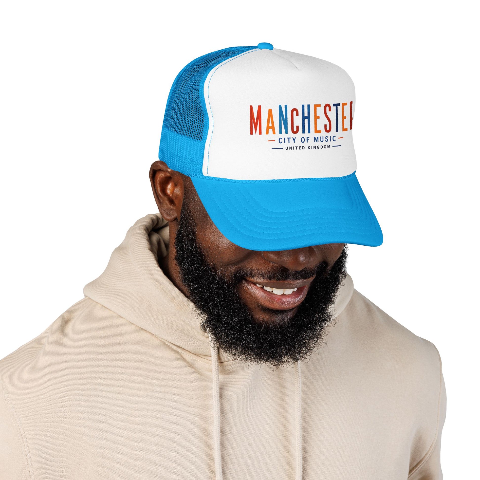 Blue mesh back trucker hat with white front panel and Manchester City of Music logo
