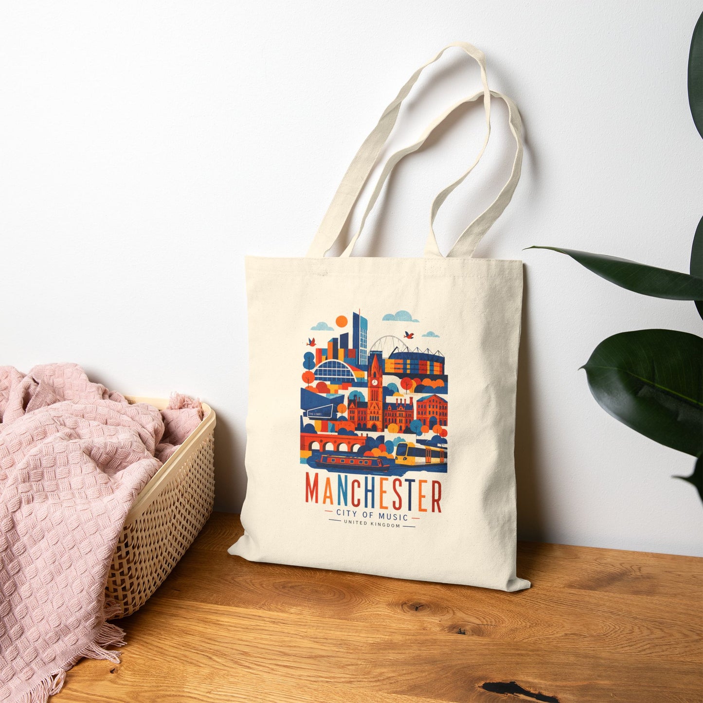 Natural cotton tote bag with long handles and Manchester skyline graphic front.