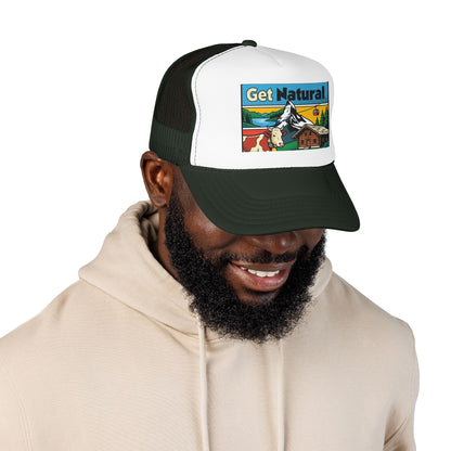 Black and white trucker hat with front alpine graphic patch; worn by a person.