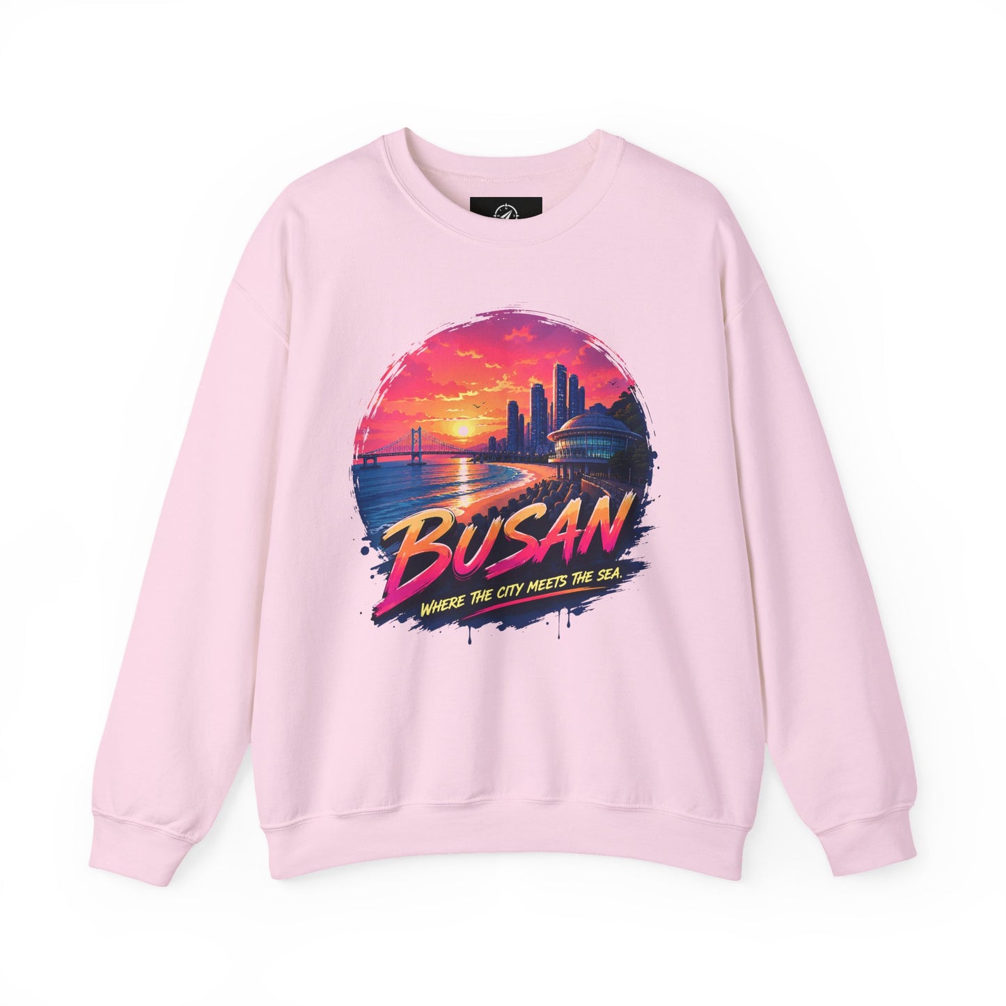 Light pink crewneck sweatshirt with long sleeves and colorful front cityscape graphic.