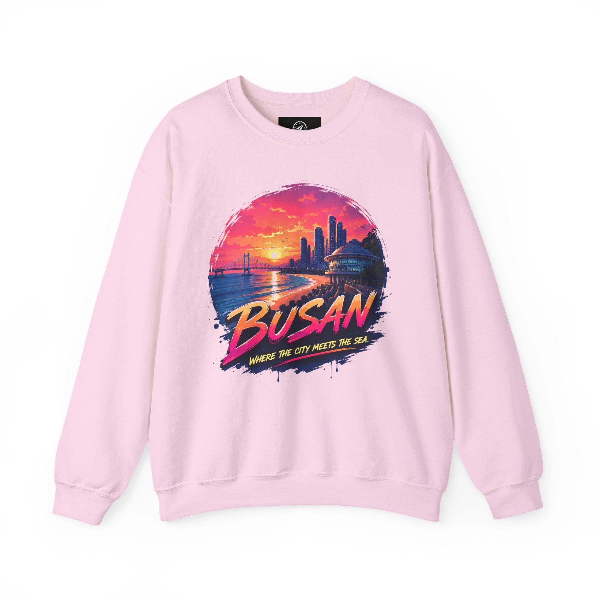 Light pink crewneck sweatshirt with long sleeves and colorful front cityscape graphic.