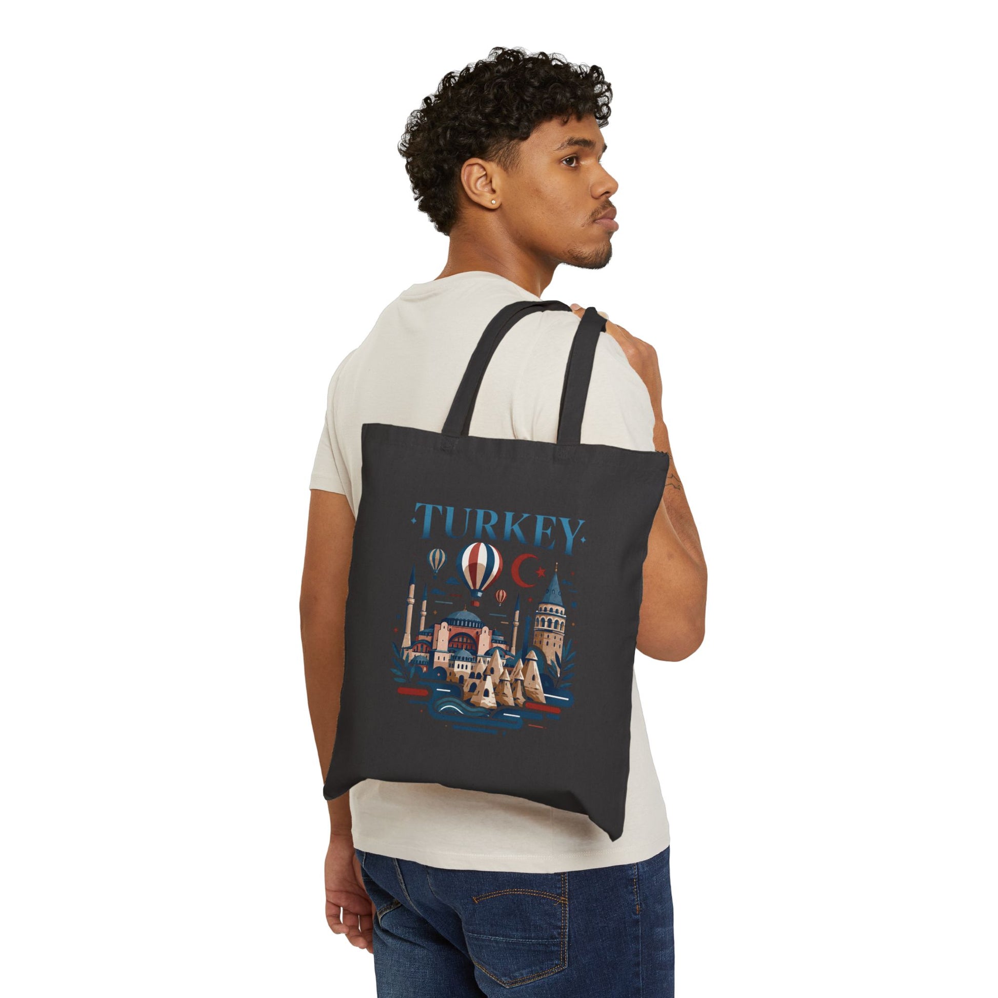 Black canvas tote bag with Turkey graphic print, worn over the shoulder