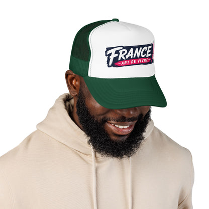 Green and white trucker hat with mesh back and 'FRANCE Art de Vivre' front patch on model