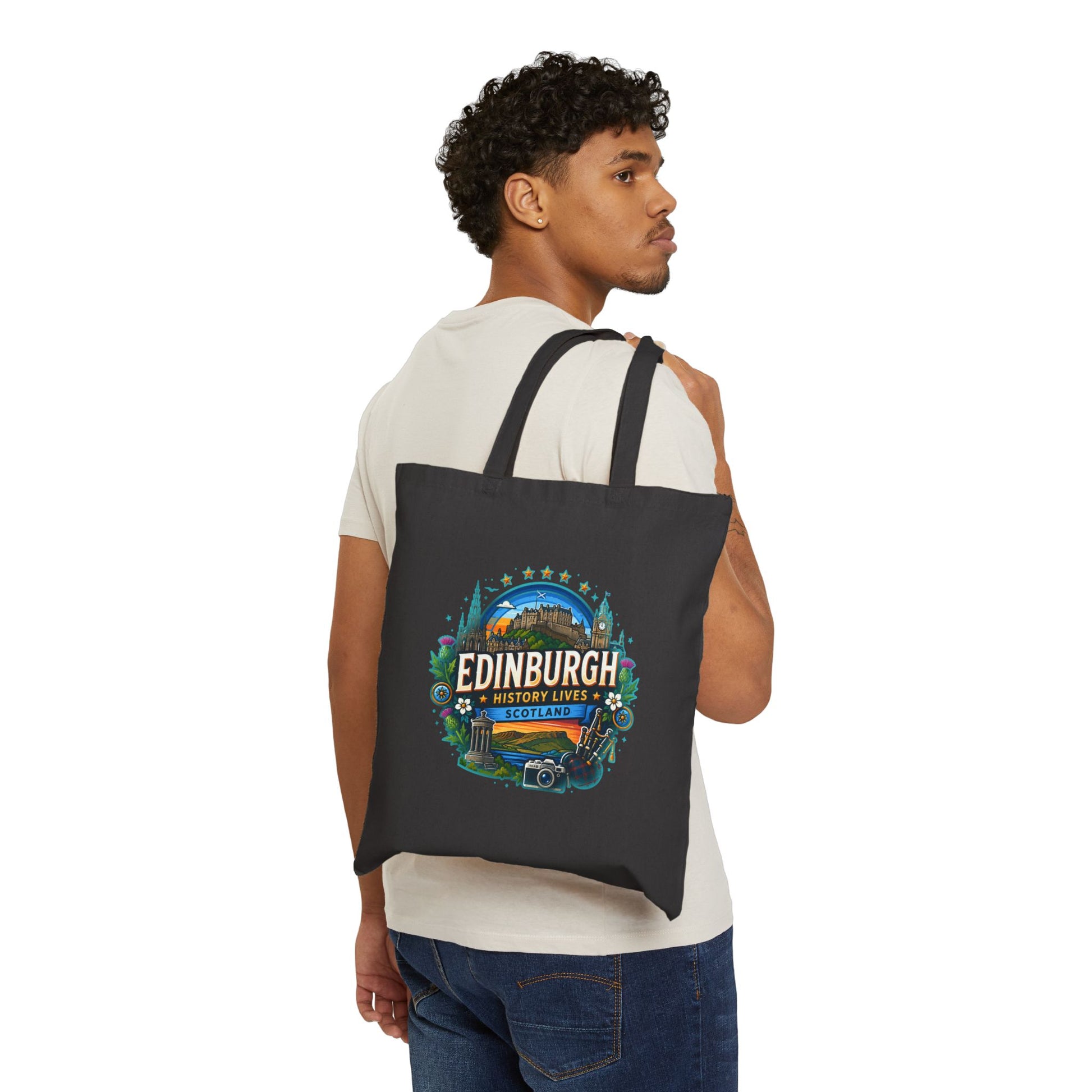 Black canvas tote bag worn on shoulder with Edinburgh logo print