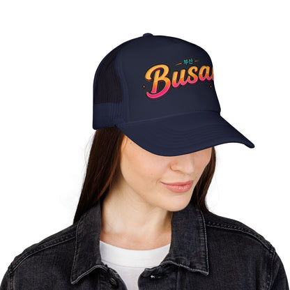Navy trucker hat with “Busan” front logo and curved brim