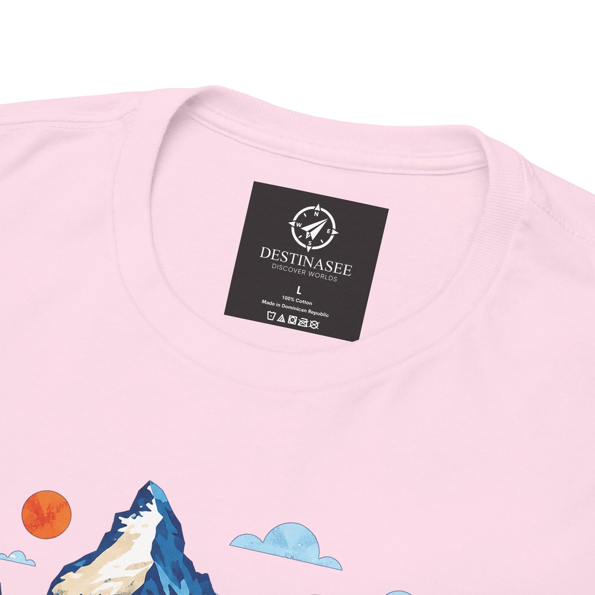 Light pink T-shirt neckline with brand label and partial mountain village print