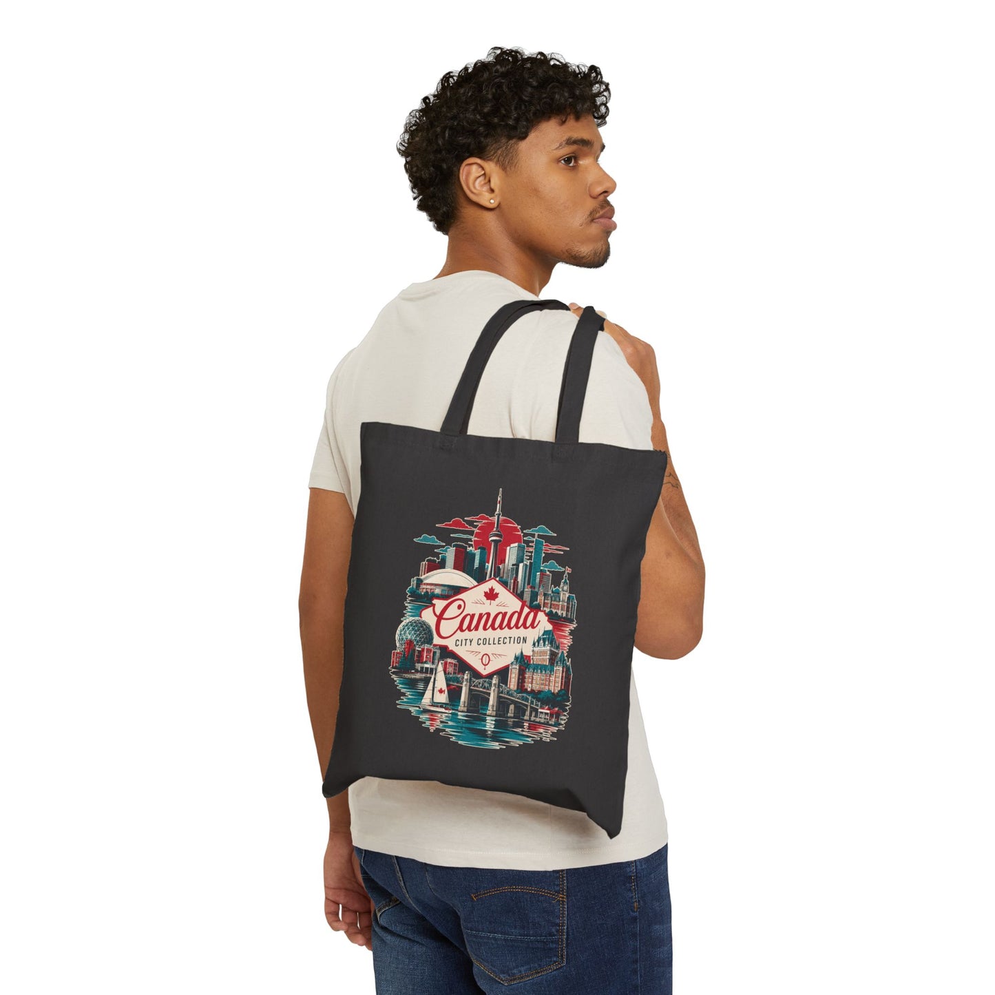 Black canvas tote bag with colorful Canada city skyline graphic, two handles.