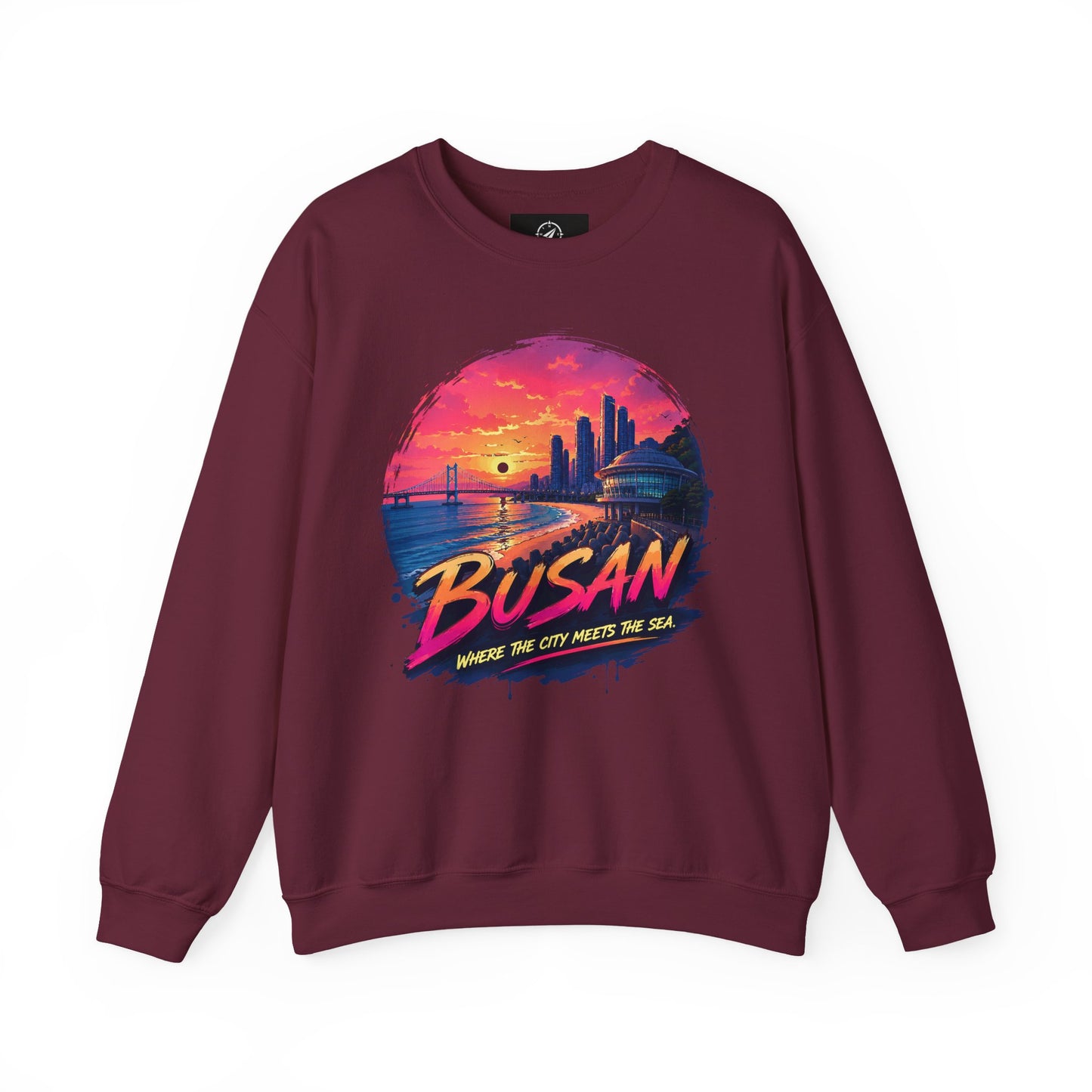 Maroon crewneck sweatshirt with colorful Busan sunrise city graphic on the chest.