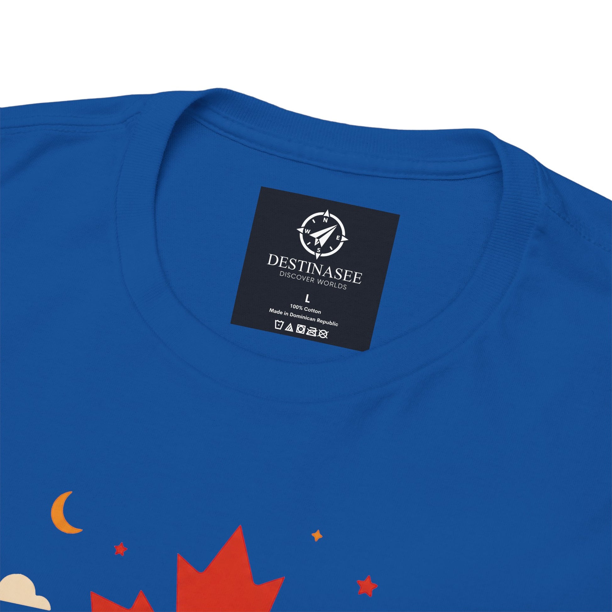 Royal blue T-shirt close-up with “DestiNasee” patch and maple leaf graphic