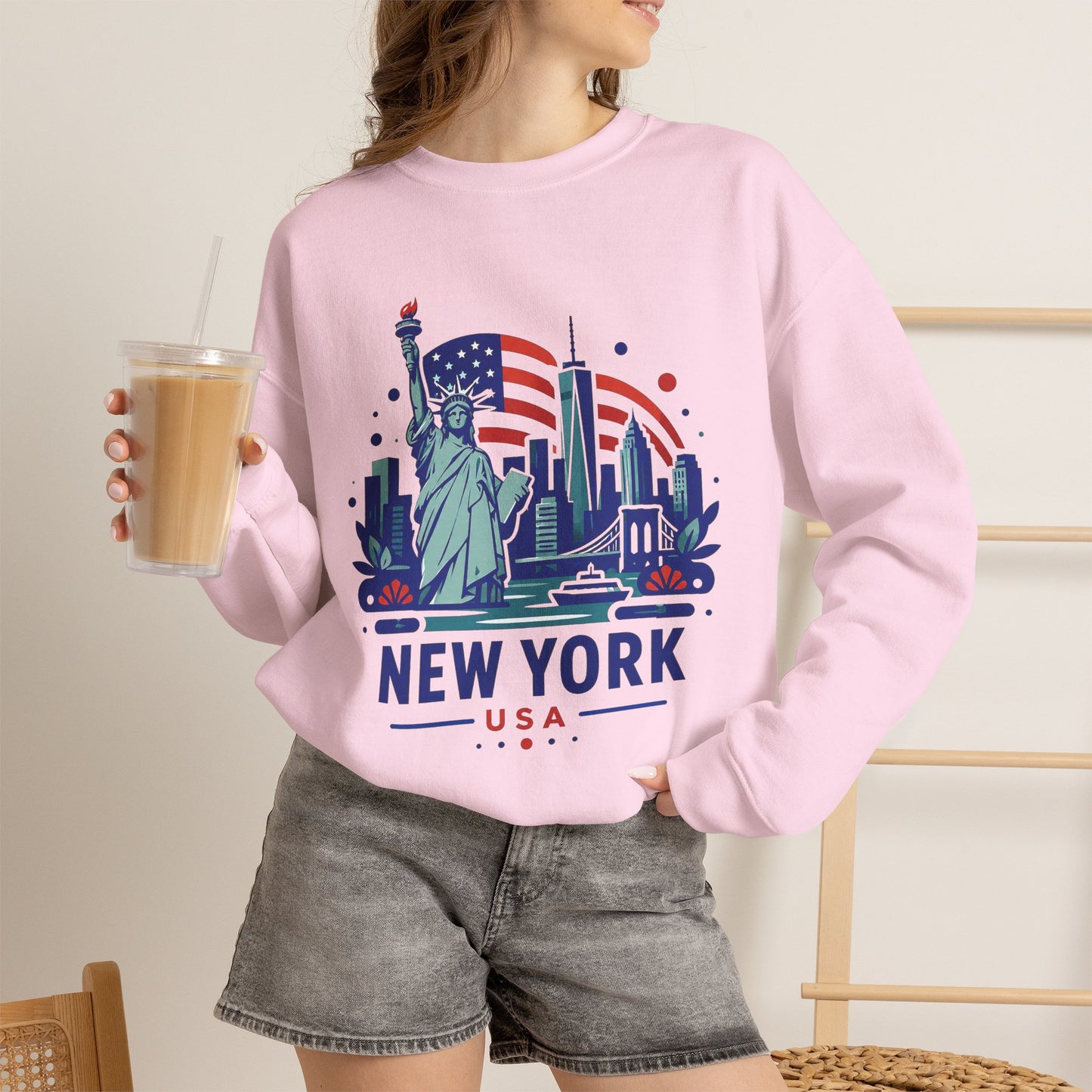 Pink crewneck sweatshirt with New York USA Statue of Liberty graphic on front