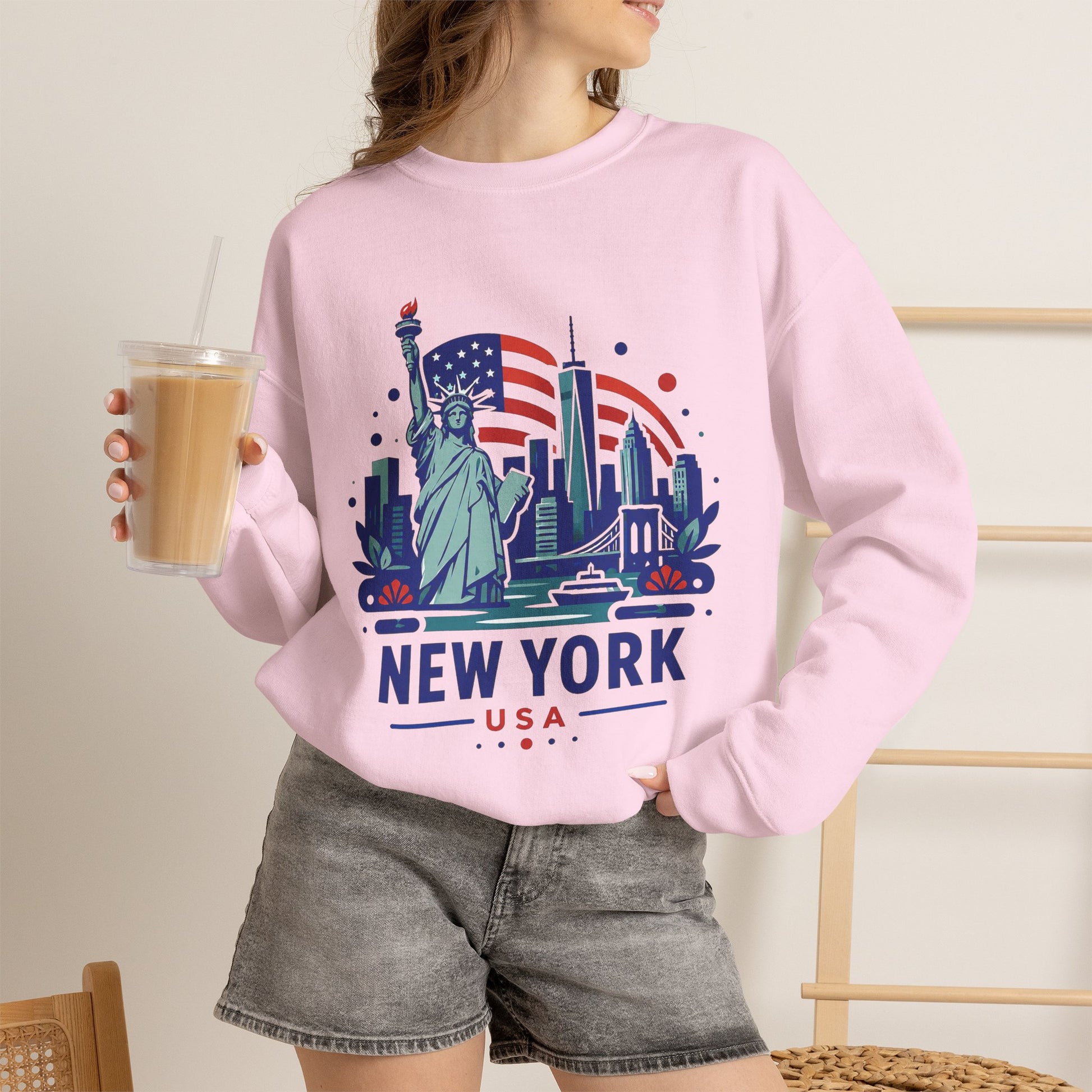 Pink crewneck sweatshirt with New York USA Statue of Liberty graphic on front