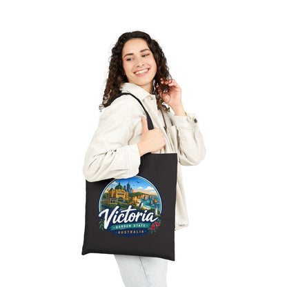 Black canvas tote bag with circular Victoria graphic and top handles
