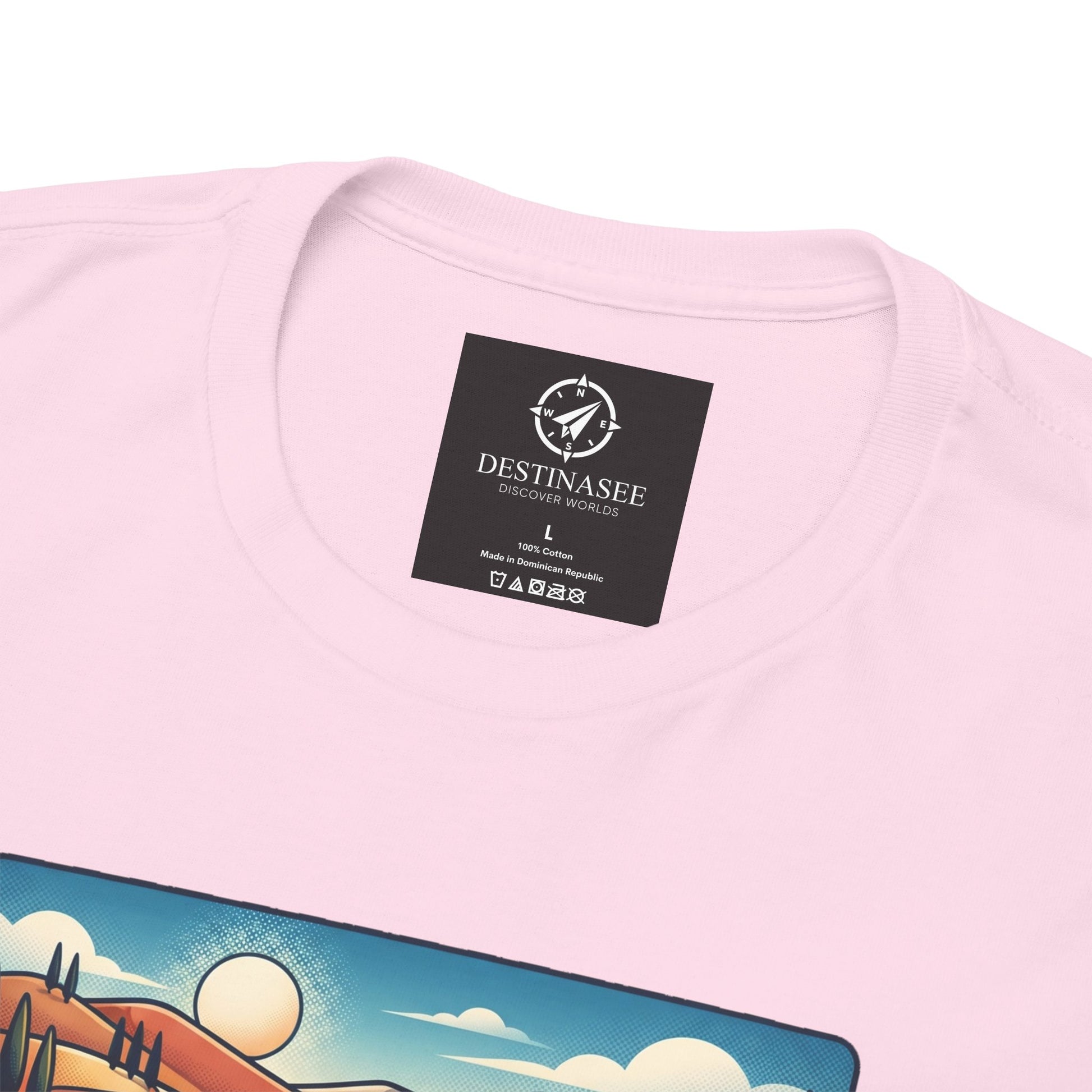 Light pink T-shirt close-up: crew neckline with black logo label, partial scenic print