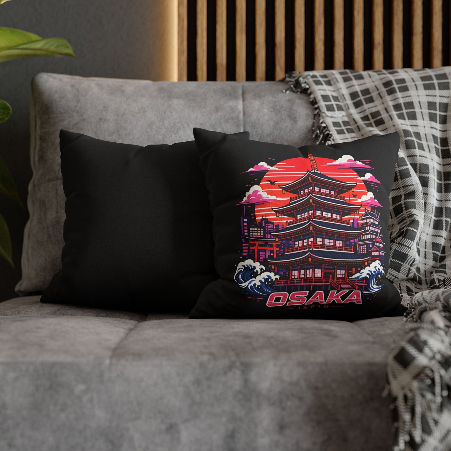 Black decor pillowcase with Osaka temple graphic on a sofa