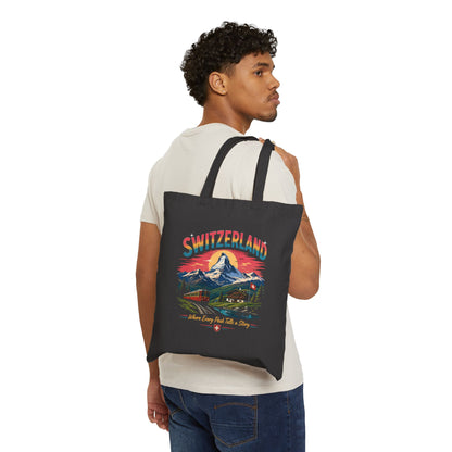 Black canvas tote bag with Switzerland graphic, carried over shoulder.