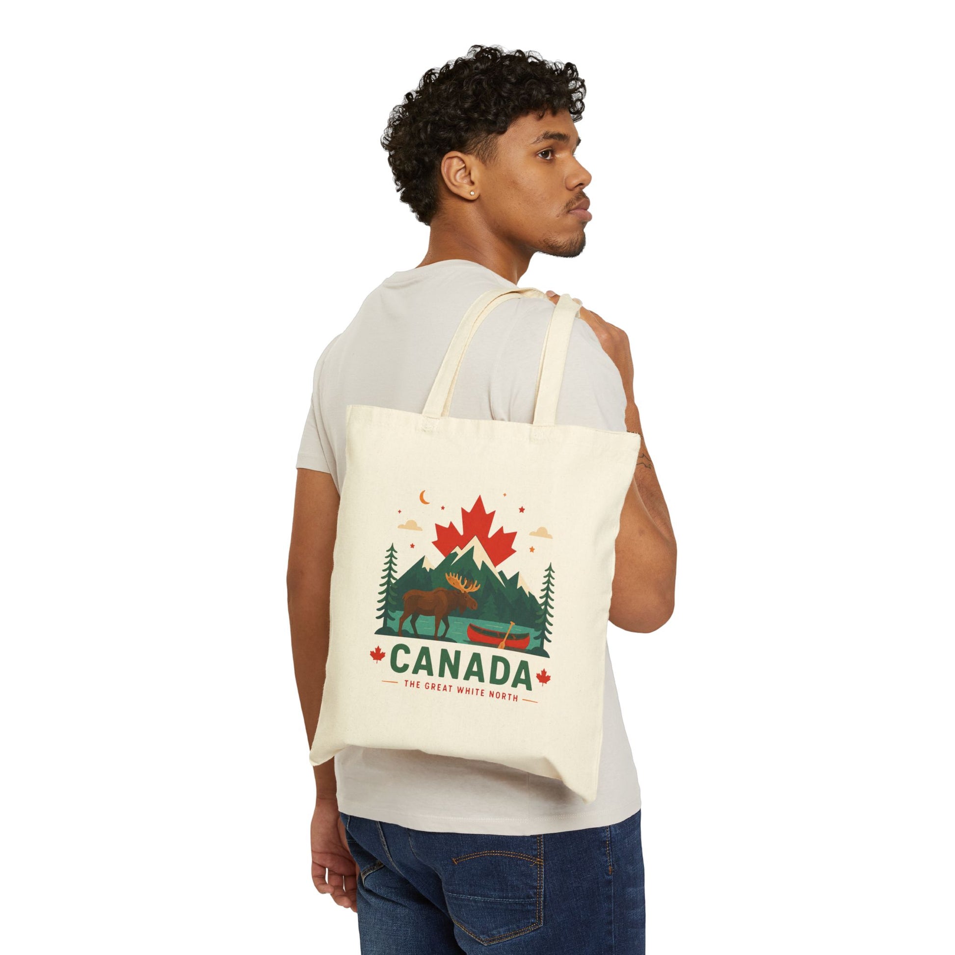 Natural canvas tote bag with Canada moose graphic, carried over shoulder