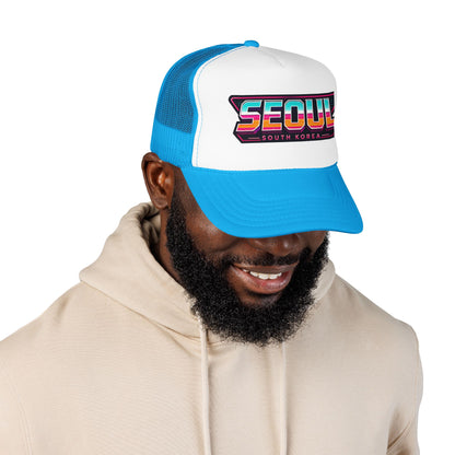 Blue and white trucker hat with “SEOUL South Korea” logo patch, worn by model