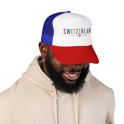 Blue and white foam trucker cap with red brim and 'SWITZERLAND' logo; worn