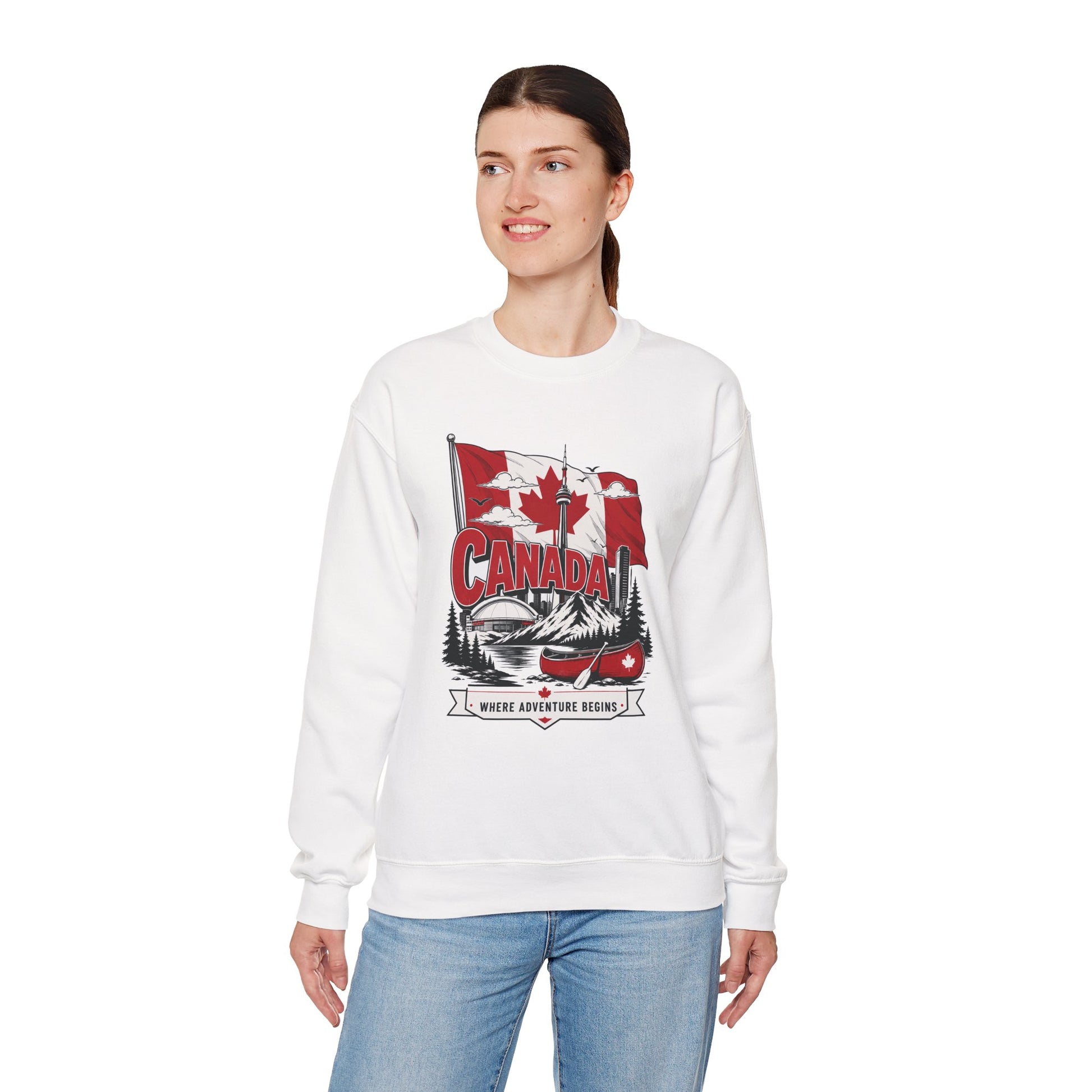 White crewneck sweatshirt on model with Canada flag canoe graphic and long sleeves.