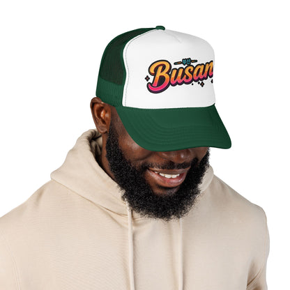 Dark green and white trucker hat with curved brim and 'Busan' logo
