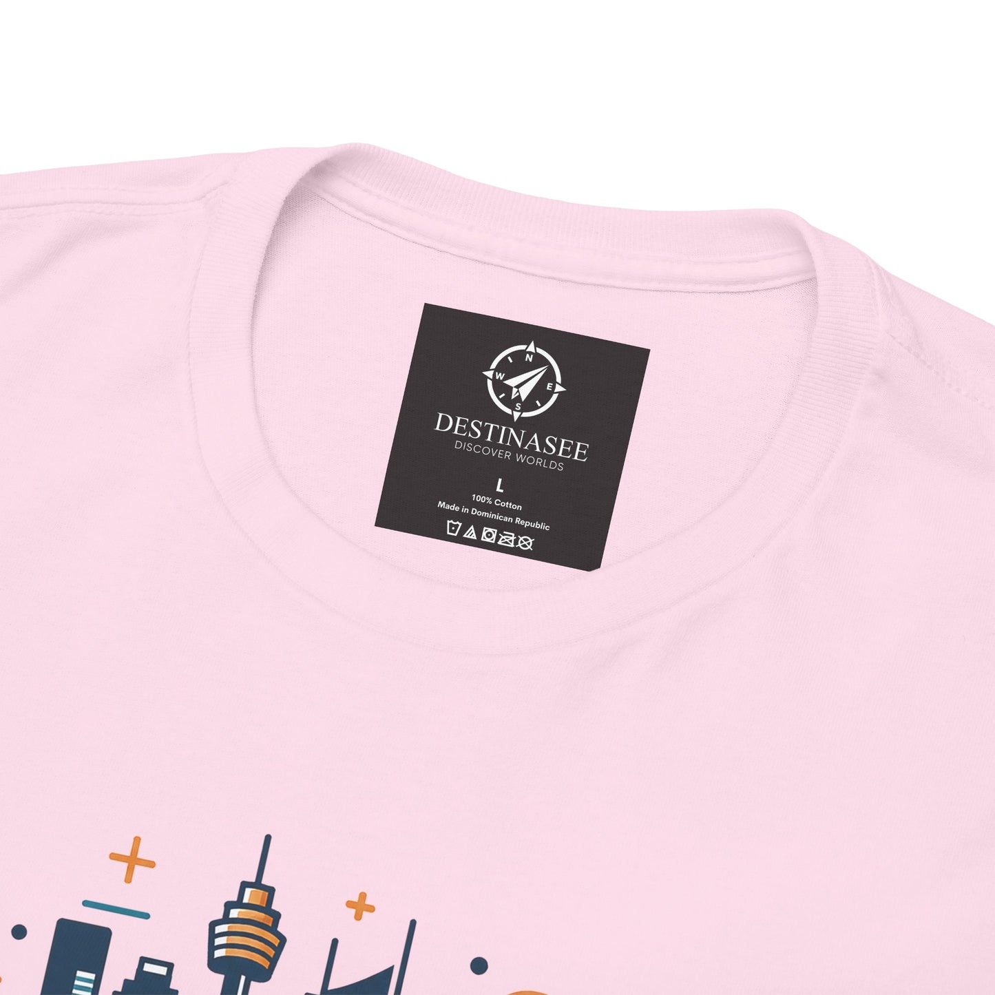 Light pink T-shirt with black neck label and partial cityscape graphic
