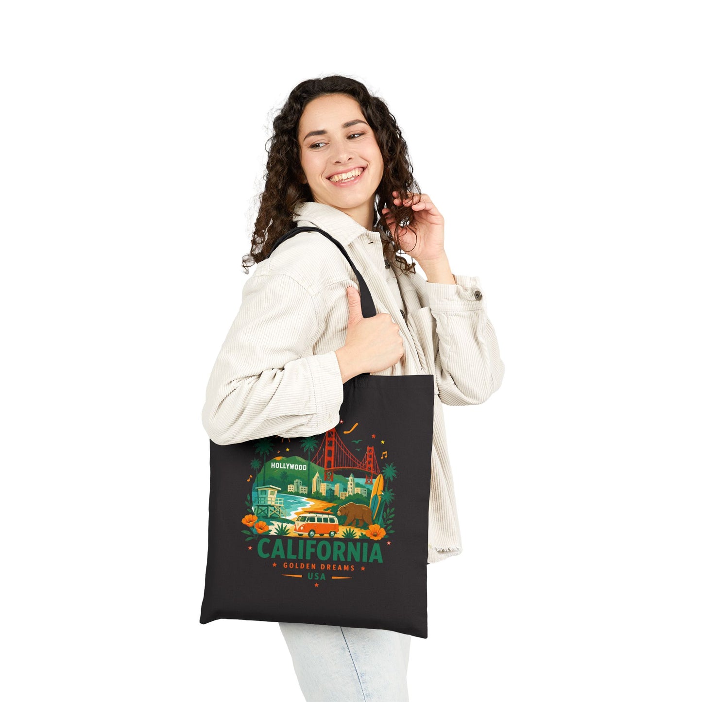 Black canvas tote bag worn by person with California graphic on front