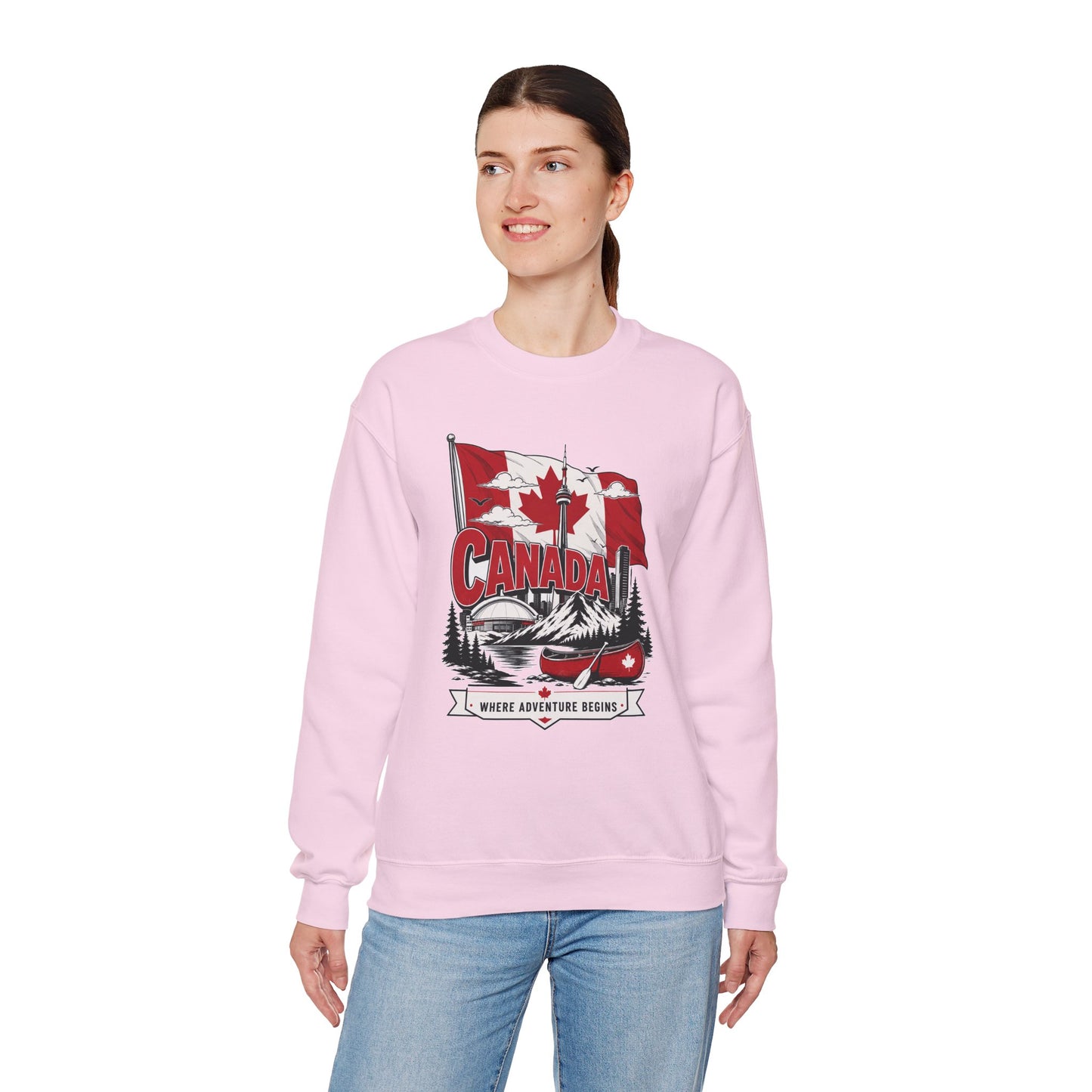 Light pink crewneck sweatshirt on model with Canada flag canoe graphic and long sleeves.